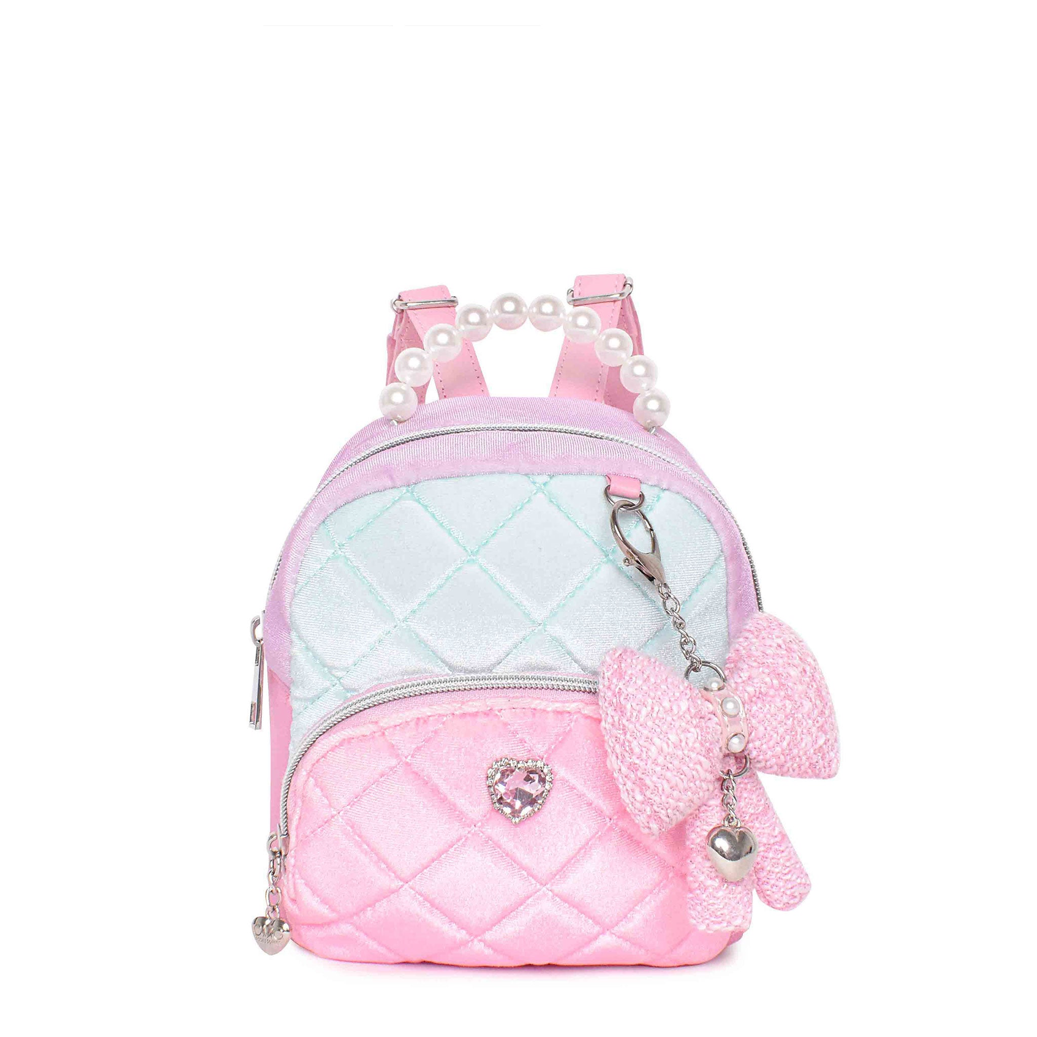 Color blocked quilted mini backpack with a pearl top handle and pink bow bag charm