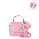 Pink handbag with bow and pearl details on a white background, labeled as a holiday best seller.