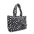 Side View of a Black and White Heart Print Nylon quilted large tote bag with matching coin purse