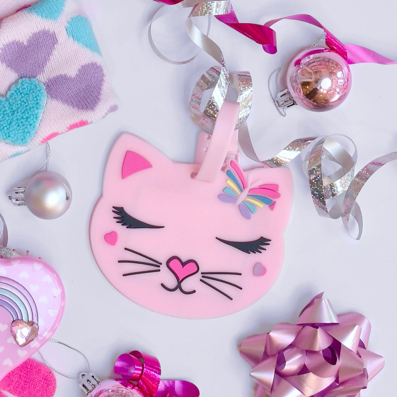 photoshoot photo of pink silicone kitty cat luggage tag set of 2