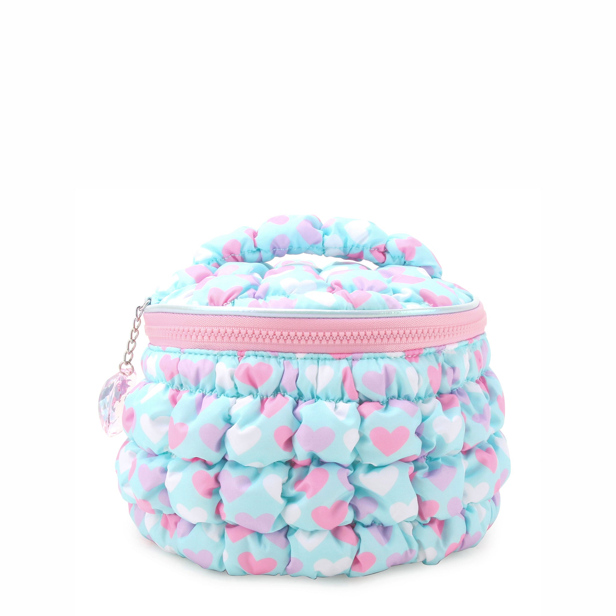 front view of a light aqua, heart-printed nylon quilted, round train case with a heart gem charm.