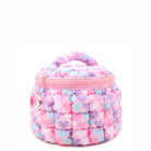 side view of a pink, heart-printed nylon quilted, round train case with a heart gem charm.