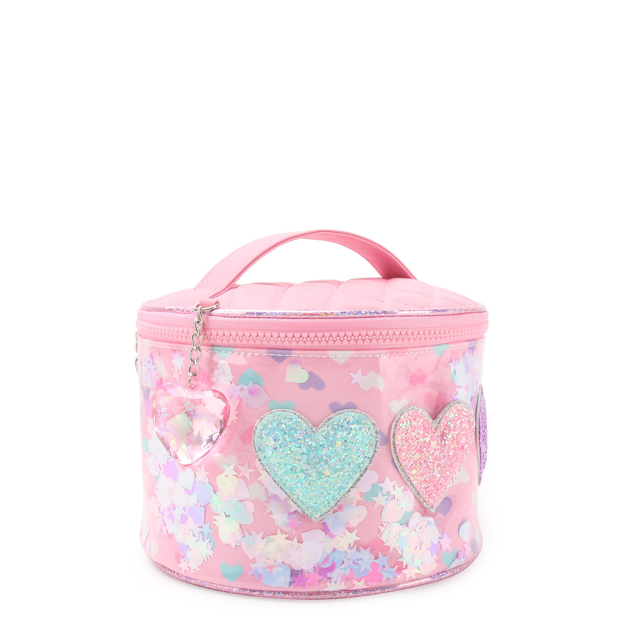 3/4 angle facing view of a pink vinyl round train case bag with top handle and heart charm. the bag is detailed with printed hearts, loose confetti, and glitter heart appliqués, and a pink crystal heart charm.