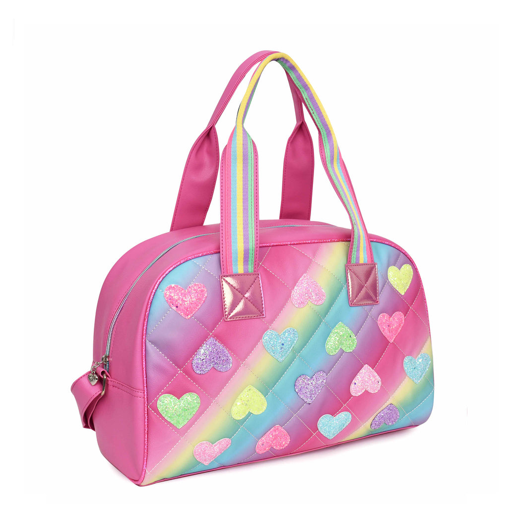 Side  view of ombre striped quitled medium duffle bag covered in glitter heart appliqués
