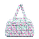 front view of a nylon quilted duffle bag  with a heart print. 