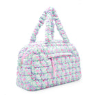 side view of a nylon quilted duffle bag  with a heart print. 