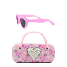 Pink sunglasses with a matching pink handbag featuring a heart design on a white background