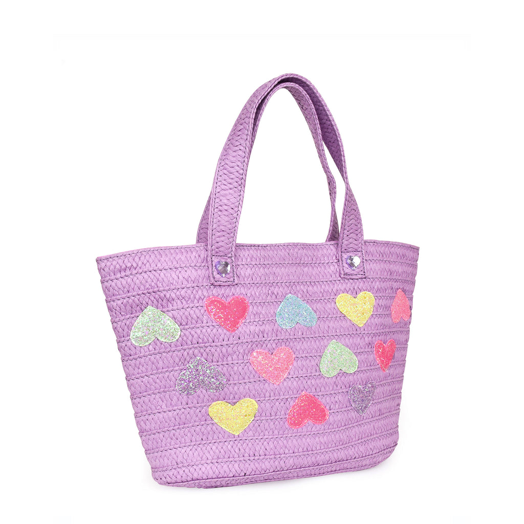 Side view of a large purple straw tote bag covered in glitter heart appliqués