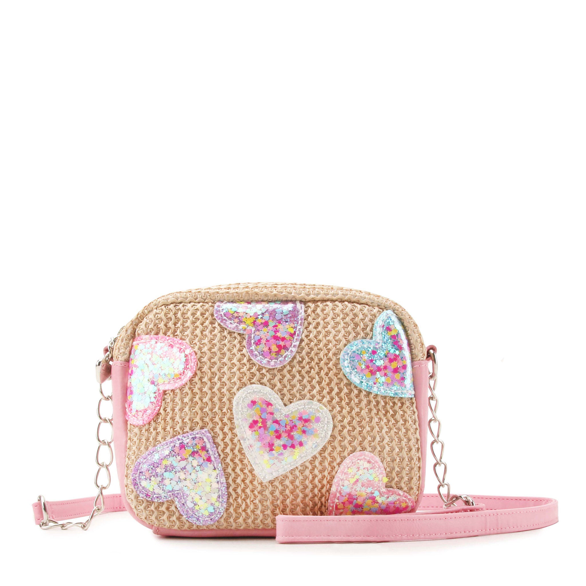 front view of a straw crossbody bag with confetti filled heart patches