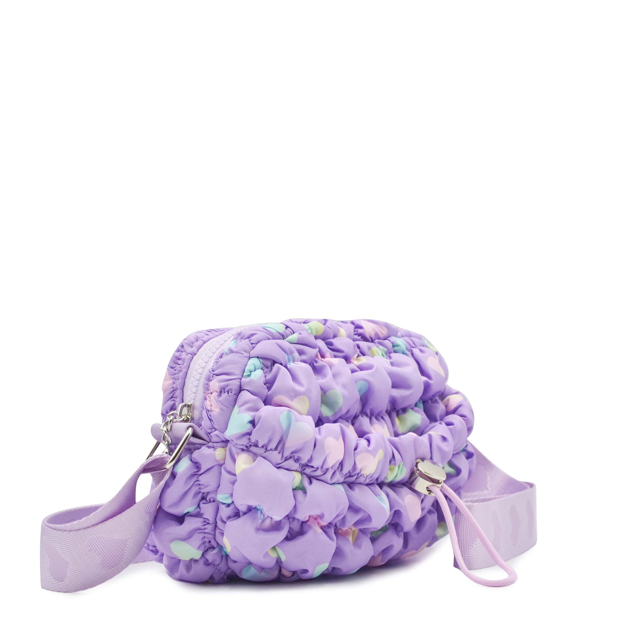 side view of a lavender heart print nylon quilted mini crossbody bag with drawstring closure and a heart strap