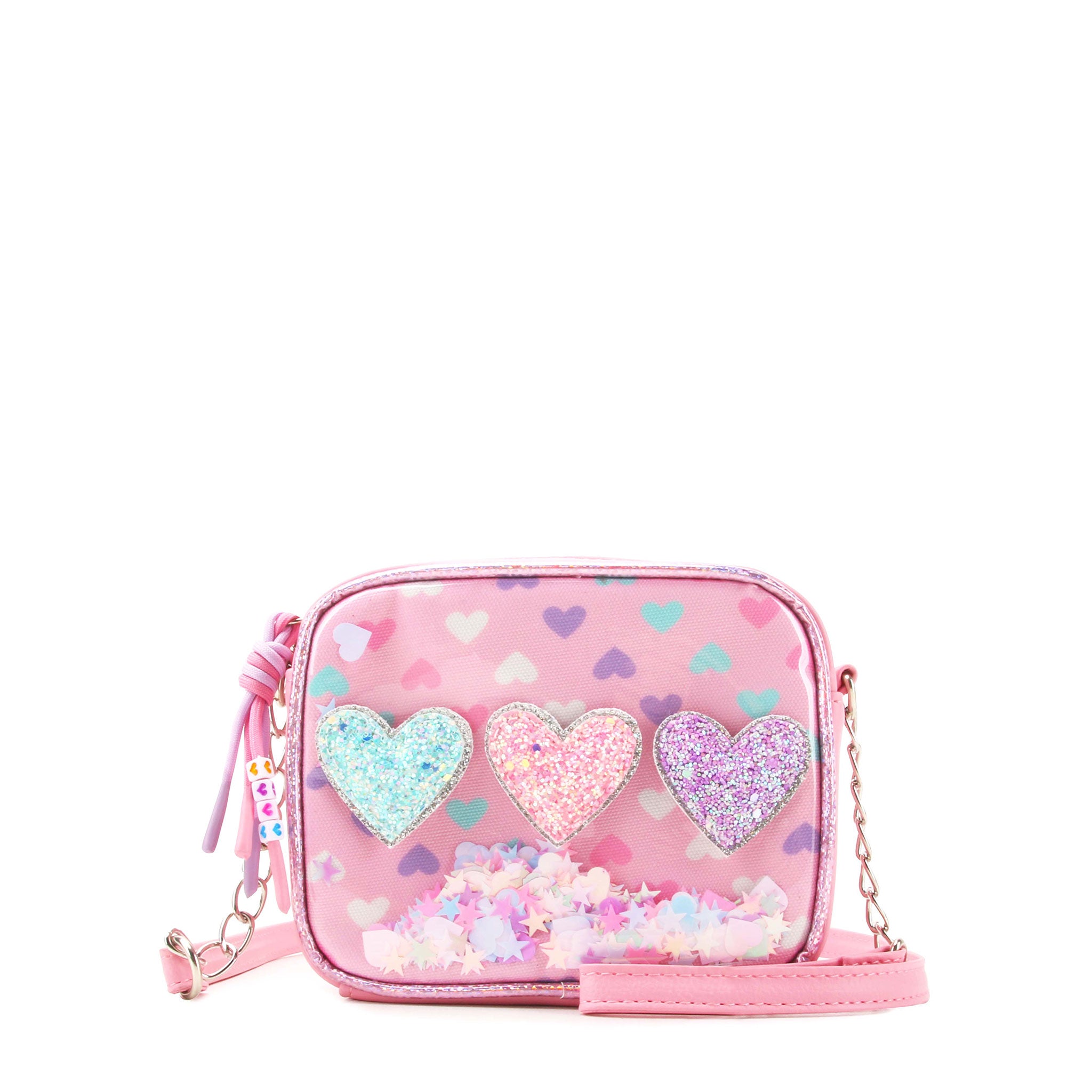 front facing view of a rectangular clear vinyl mini bag with printed hearts , glitter heart appliqués, and loose confetti