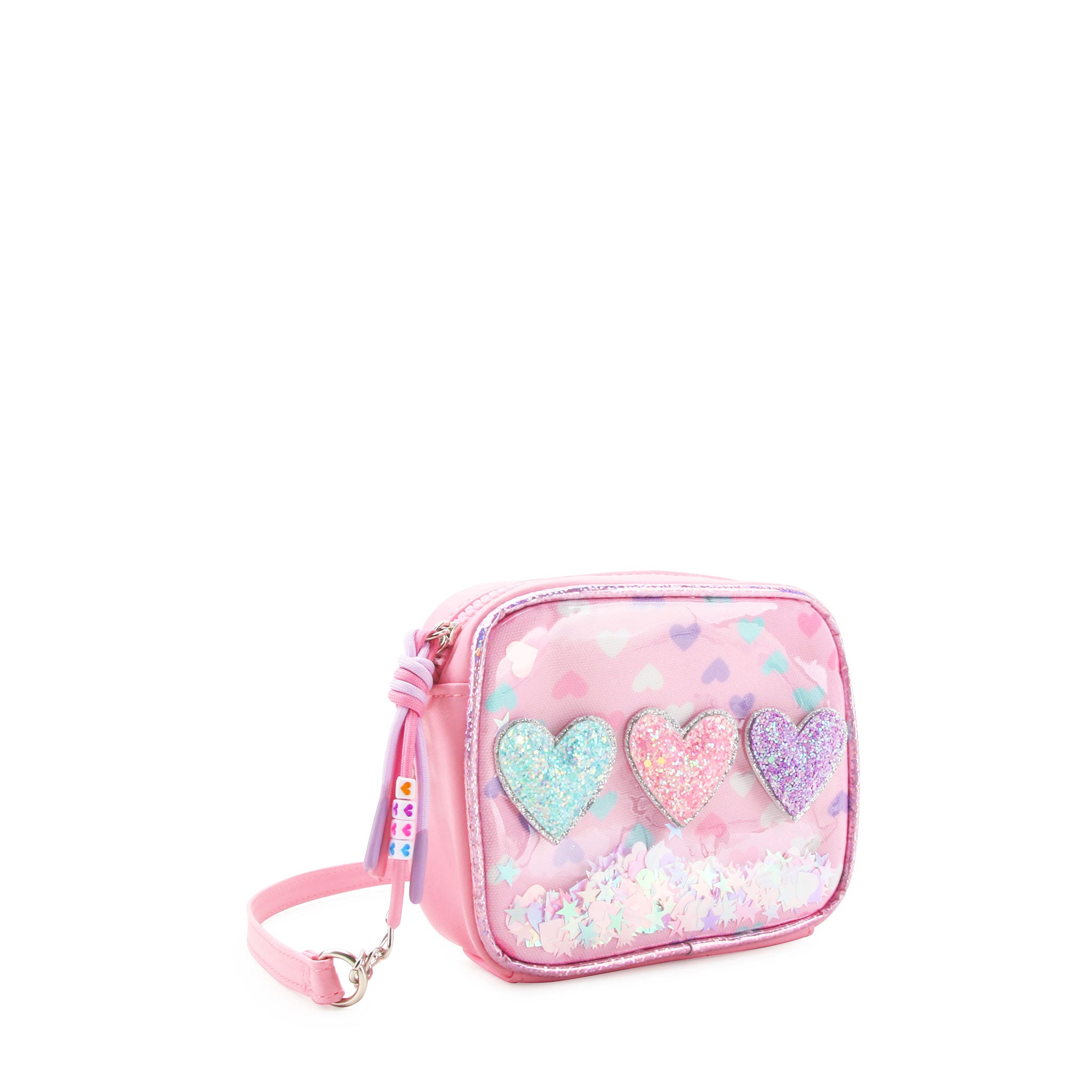 3/4 angle facing view of a rectangular clear vinyl mini bag with printed hearts , glitter heart appliqués, and loose confetti