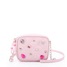 front view of a light pink quilted crossbody bag with pear, rhinestone & gem appliques  along with a heart beaded zipper pull
