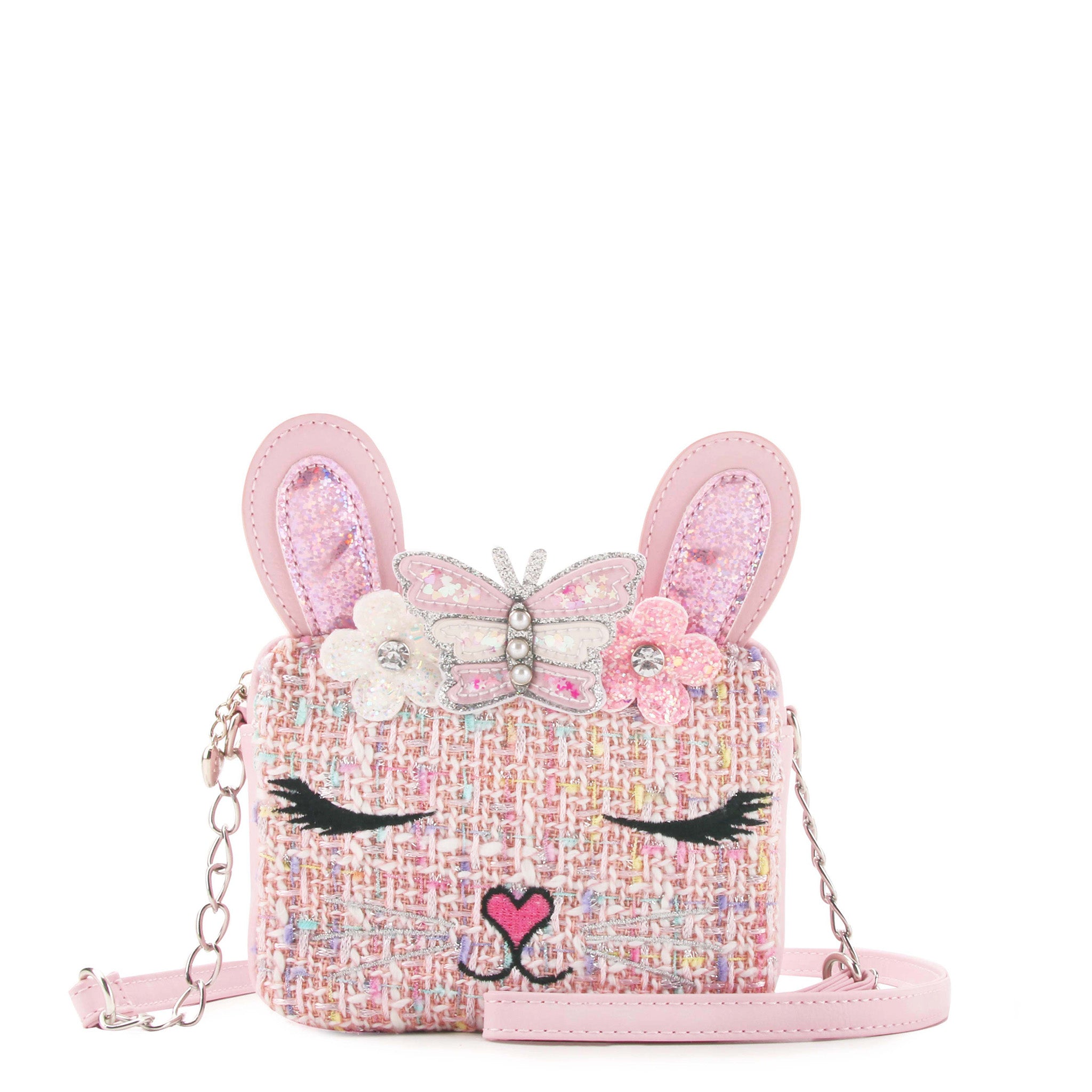 front view of a pink tweed bunny face crossbody bag with a confetti filled butterfly crown