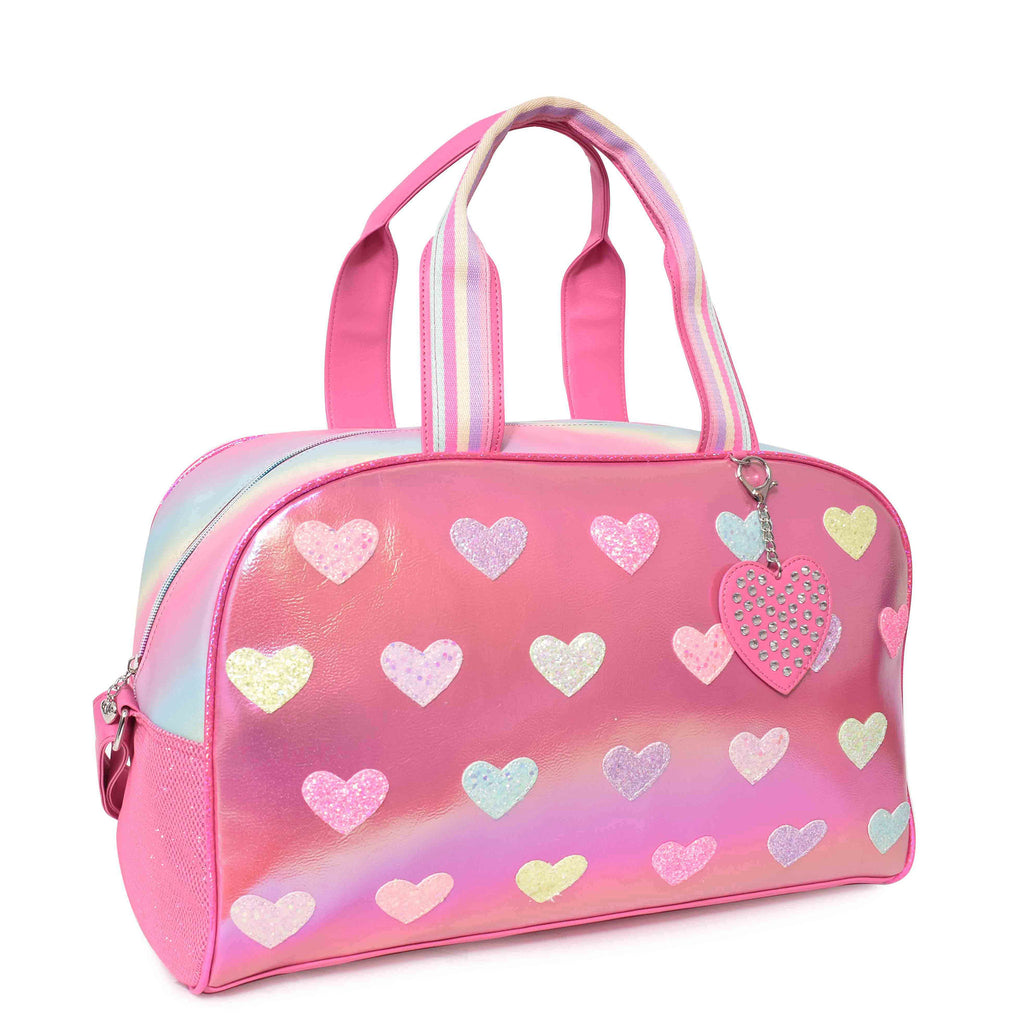 Side view of pink metallic heart-patched large duffle bag with rhinestone heart keychain