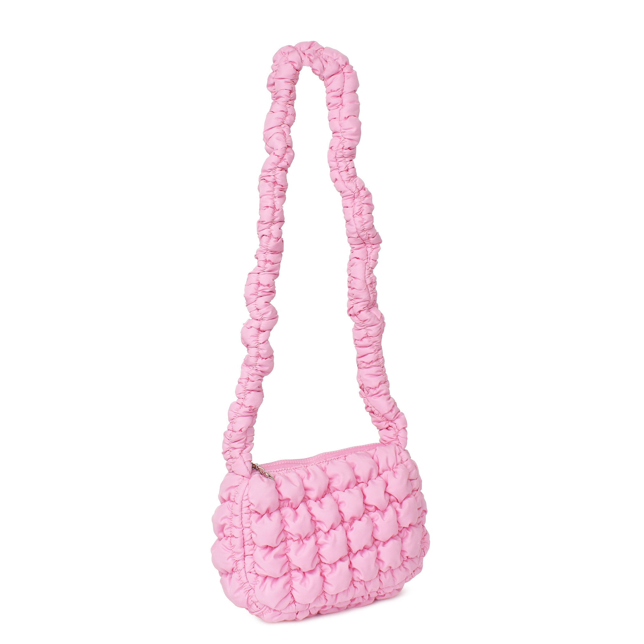 side view of a long handle scrunch hand bag in a light pink
