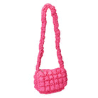 side view of a nylon quilted long handle crossbody bag in hot pink
