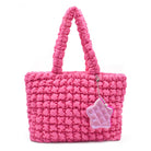 front view of a hot pink nylon quilted large tote bag with star coin purse