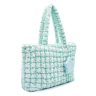 side view of a light aqua nylon quilted large tote bag with star coin purse