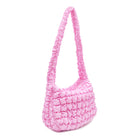 Side view of a bright pink quilted nylon sling bag 