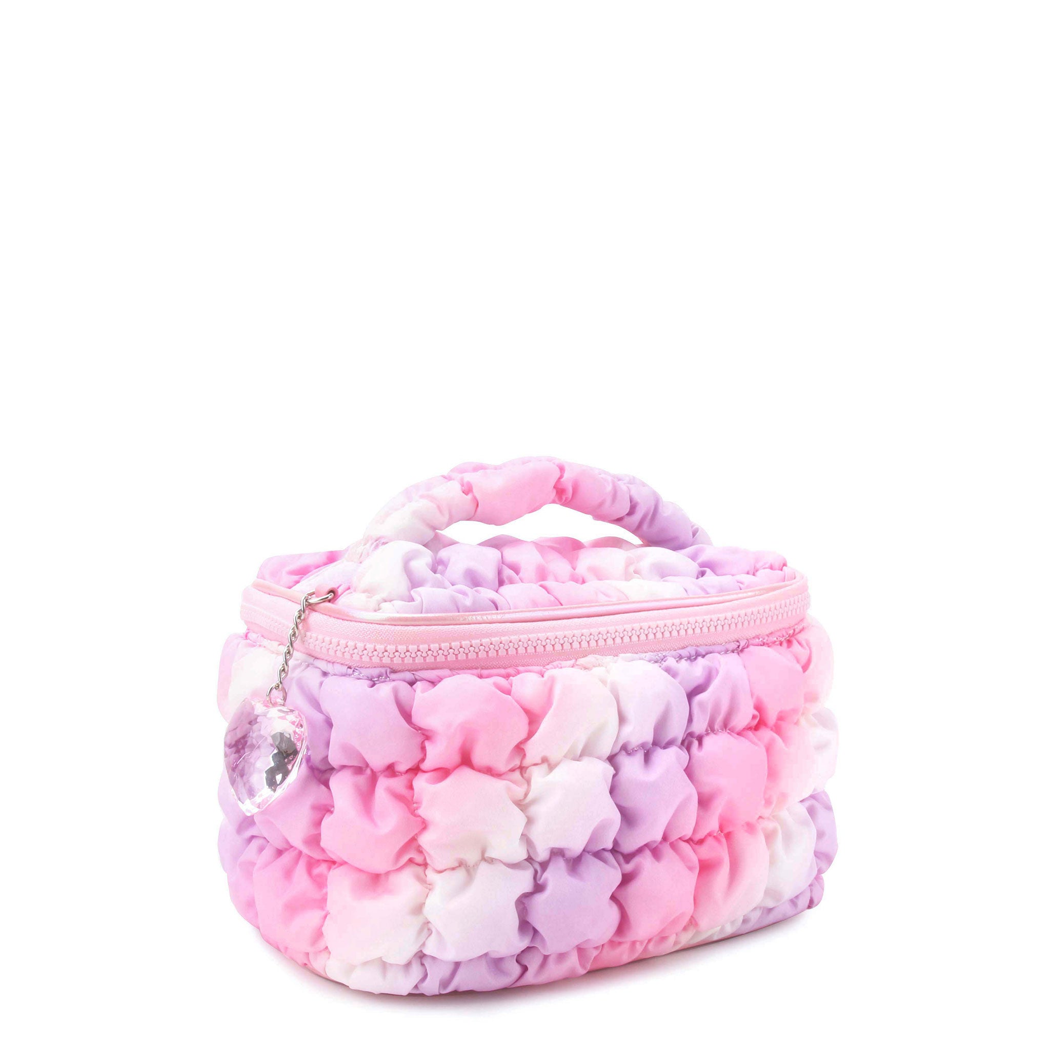 side view of an ombre quilted scrunch train case with a heart gem keychain