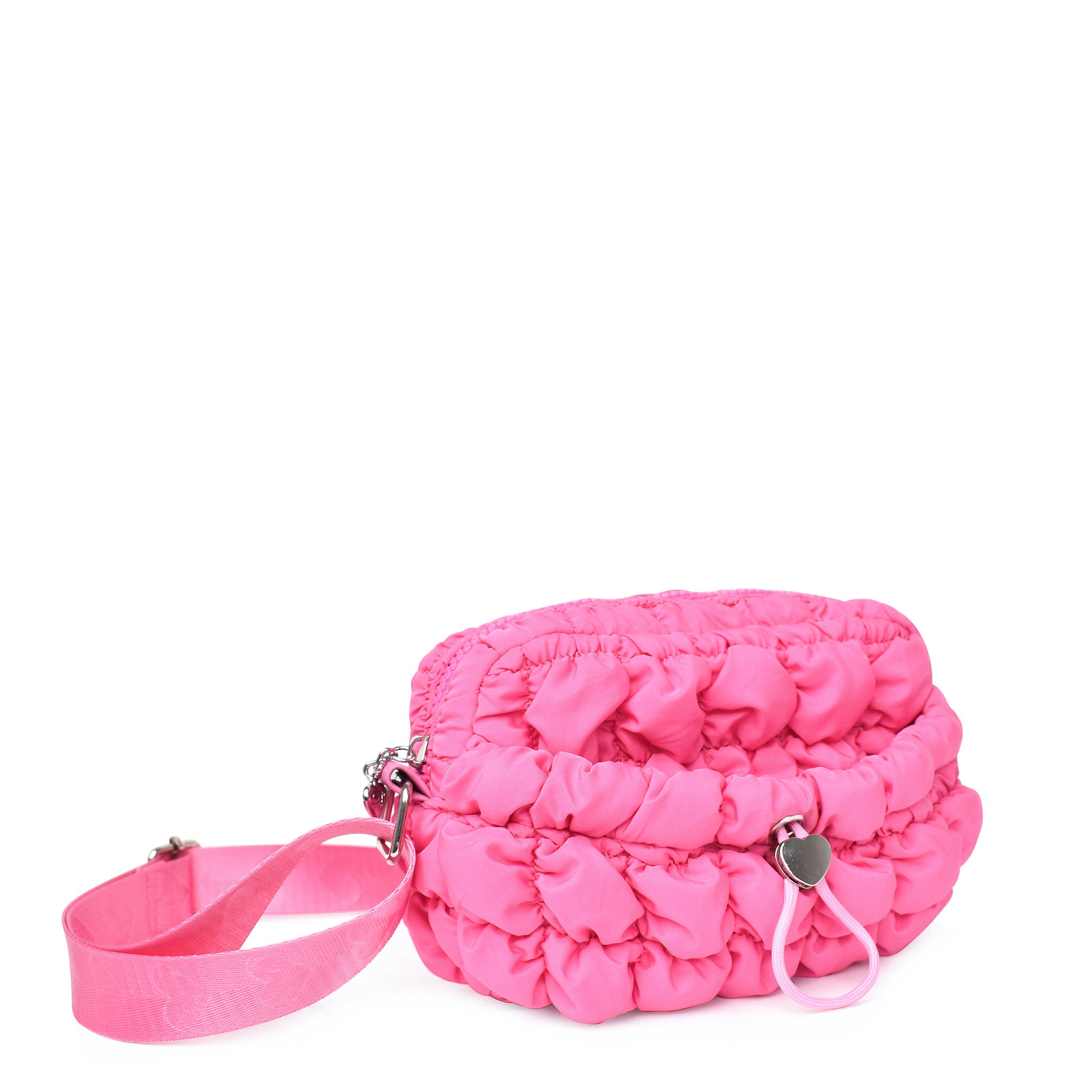 side view of a hot pink nylon quilted mini crossbody bag with drawstring closure and a heart strap