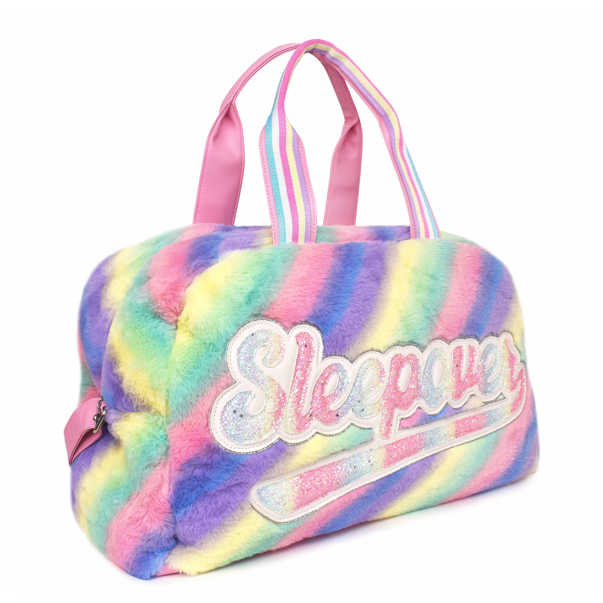 Side view of a rainbow ombre striped plush large duffle with script varsity letters 'SLEEPOVER'