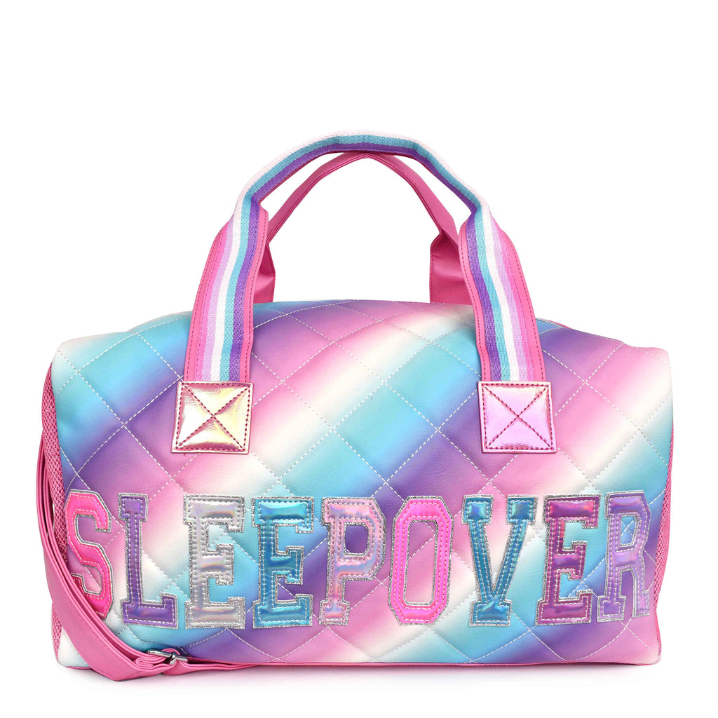 Front view of cool-toned quilted ombre large 'Sleepover' duffle with reflective varsity-letter patches