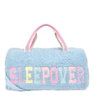 Front view of a blue sherpa large duffle bag with glitter varsity lettering 'SLEEPOVER' applique 