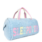 Side view of a blue sherpa large duffle bag with glitter varsity lettering 'SLEEPOVER' applique