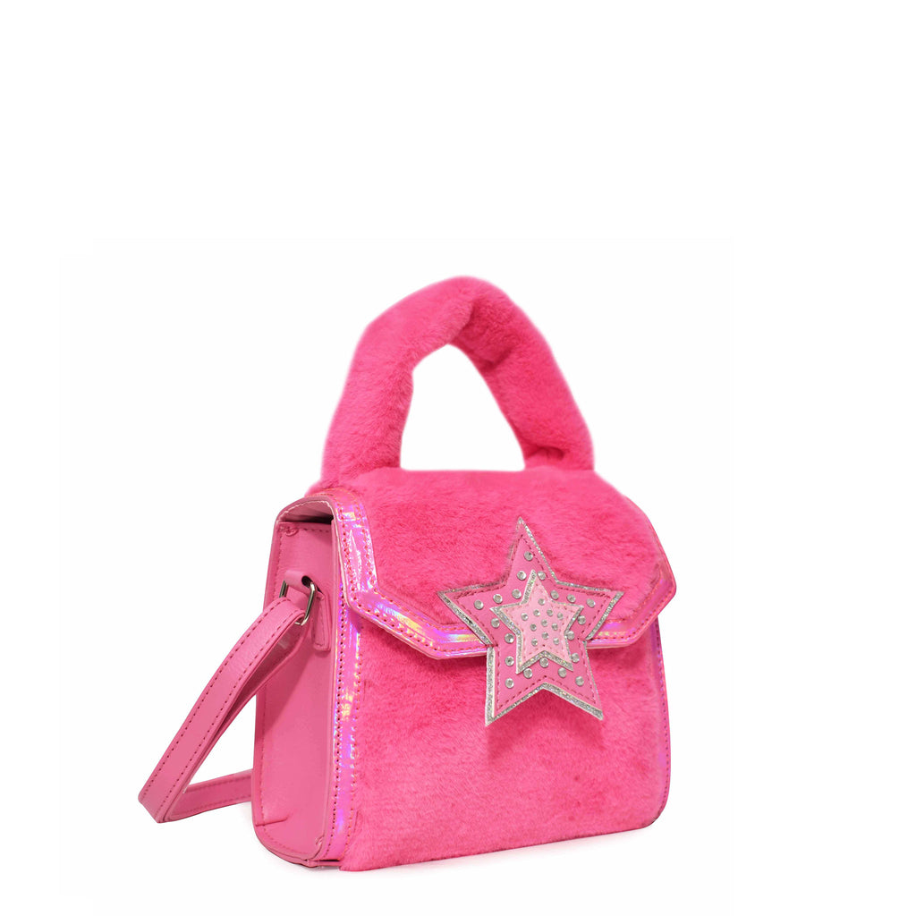 Side view of a hot pink plush top handle crossbody with rhinestone star appliqué on flap closure.