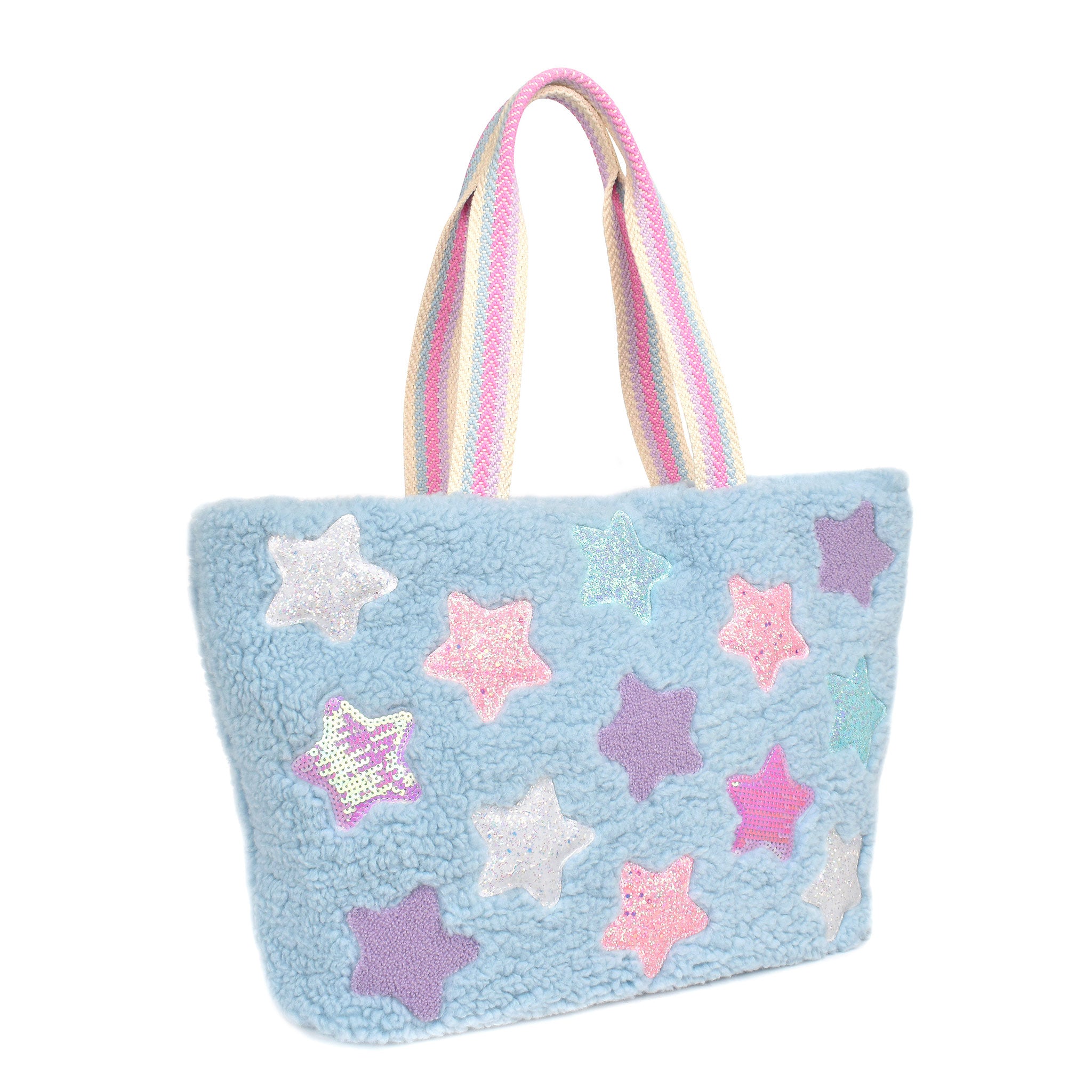 Side view of a blue sherpa large tote bag covered in sequin, chenille, and glitter star patches