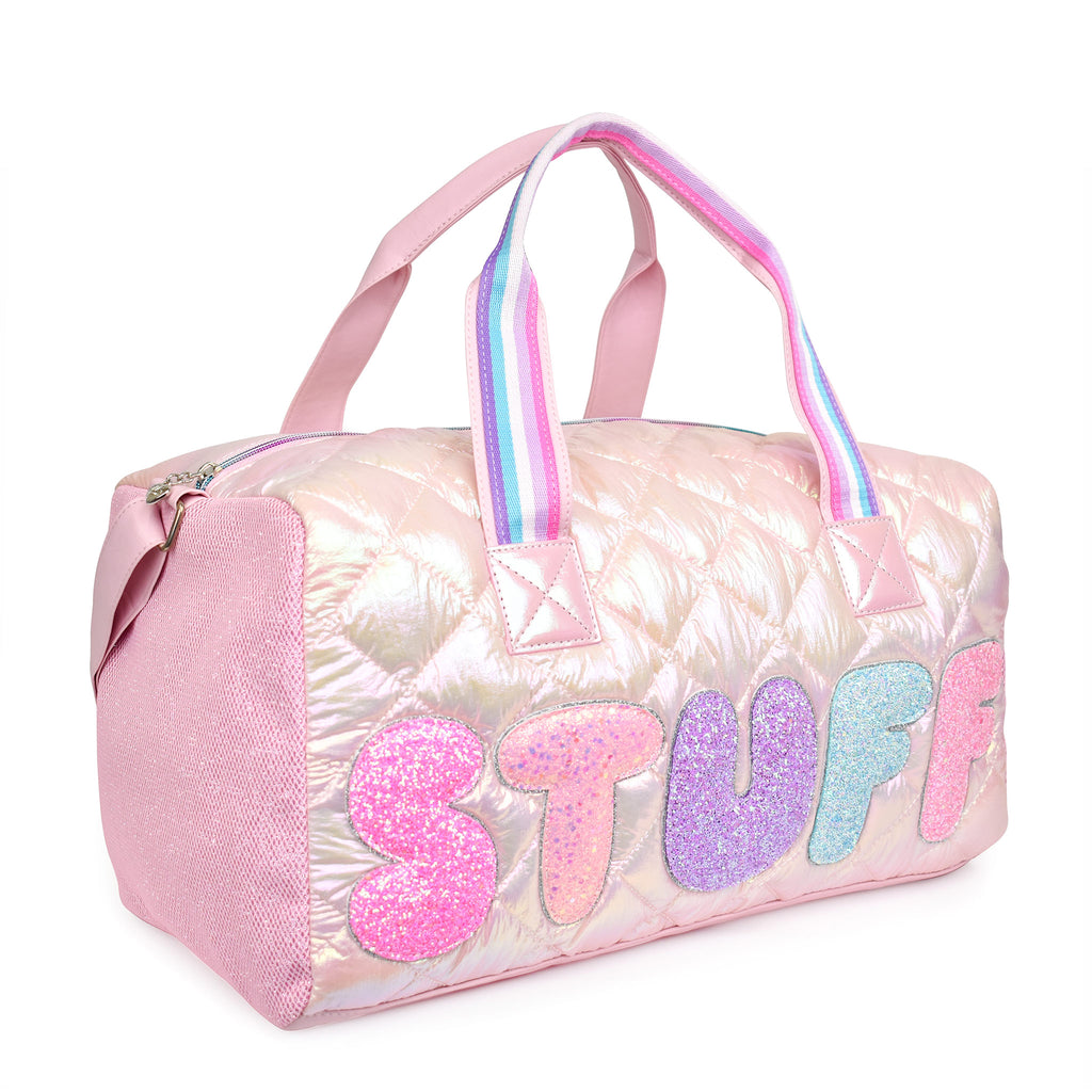 Side view of a light pink metallic quilted duffle with glitter bubble letters 'STUFF' appliqué