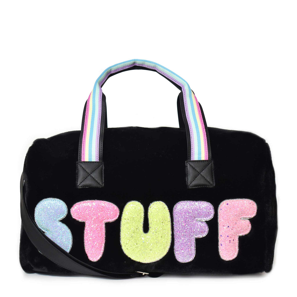 Front view of black plush large 'Stuff' duffle with glitter bubble-letter patches
