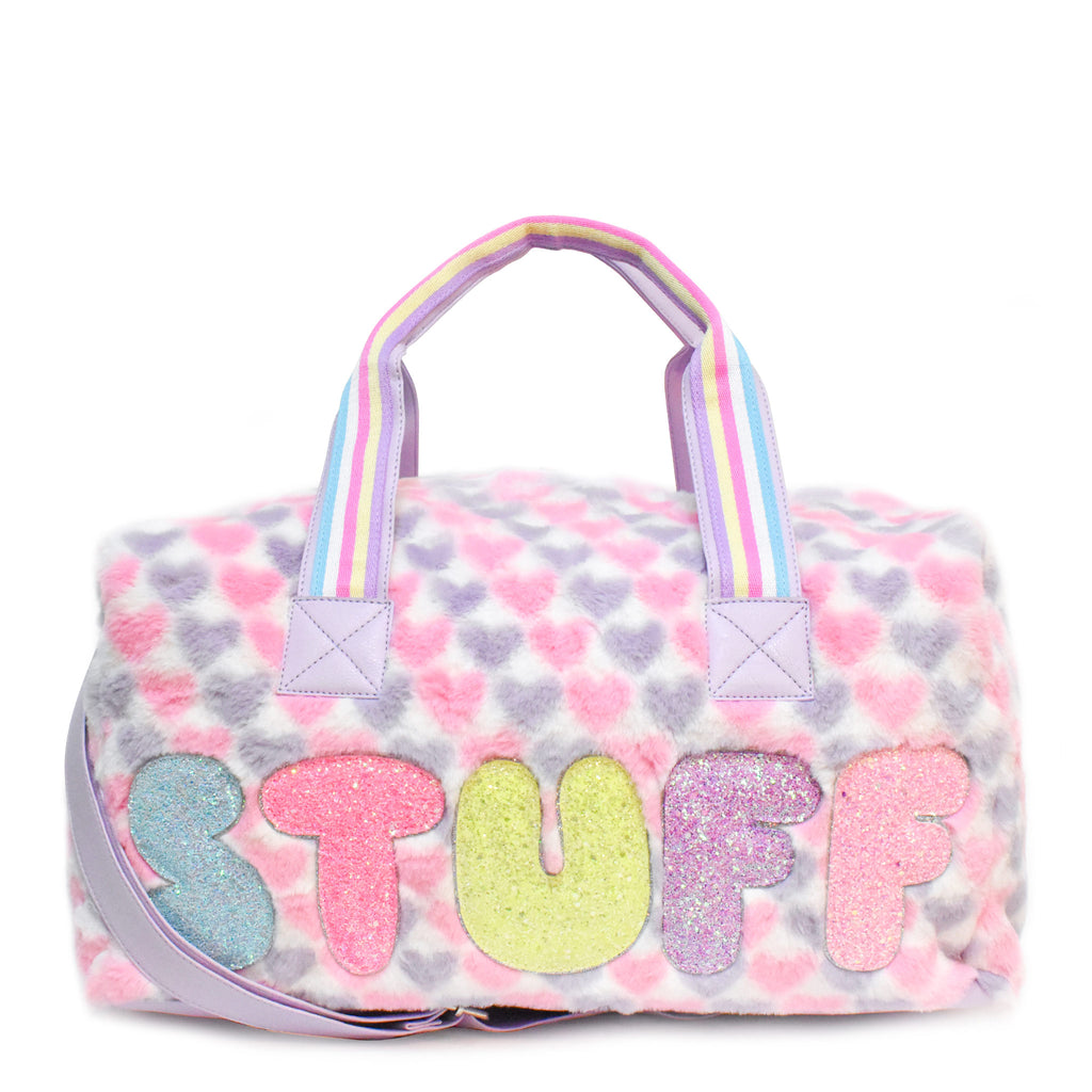 Front view of large plush pink and purple heart-printed 'stuff' duffle with glitter bubble-letter patches