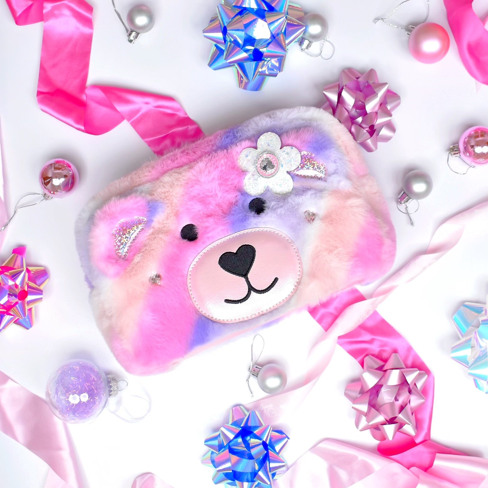 photoshoot photo of a teddy bear face plush pouch with a glitter daisy appliqué 