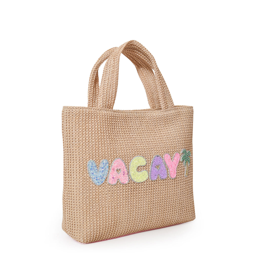 Side view of straw mini beach tote with glitter bubble-letters 'VACAY' and palm tree appliqués.