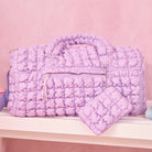 photoshoot photo of lavender quilted scrunchies duffle bag