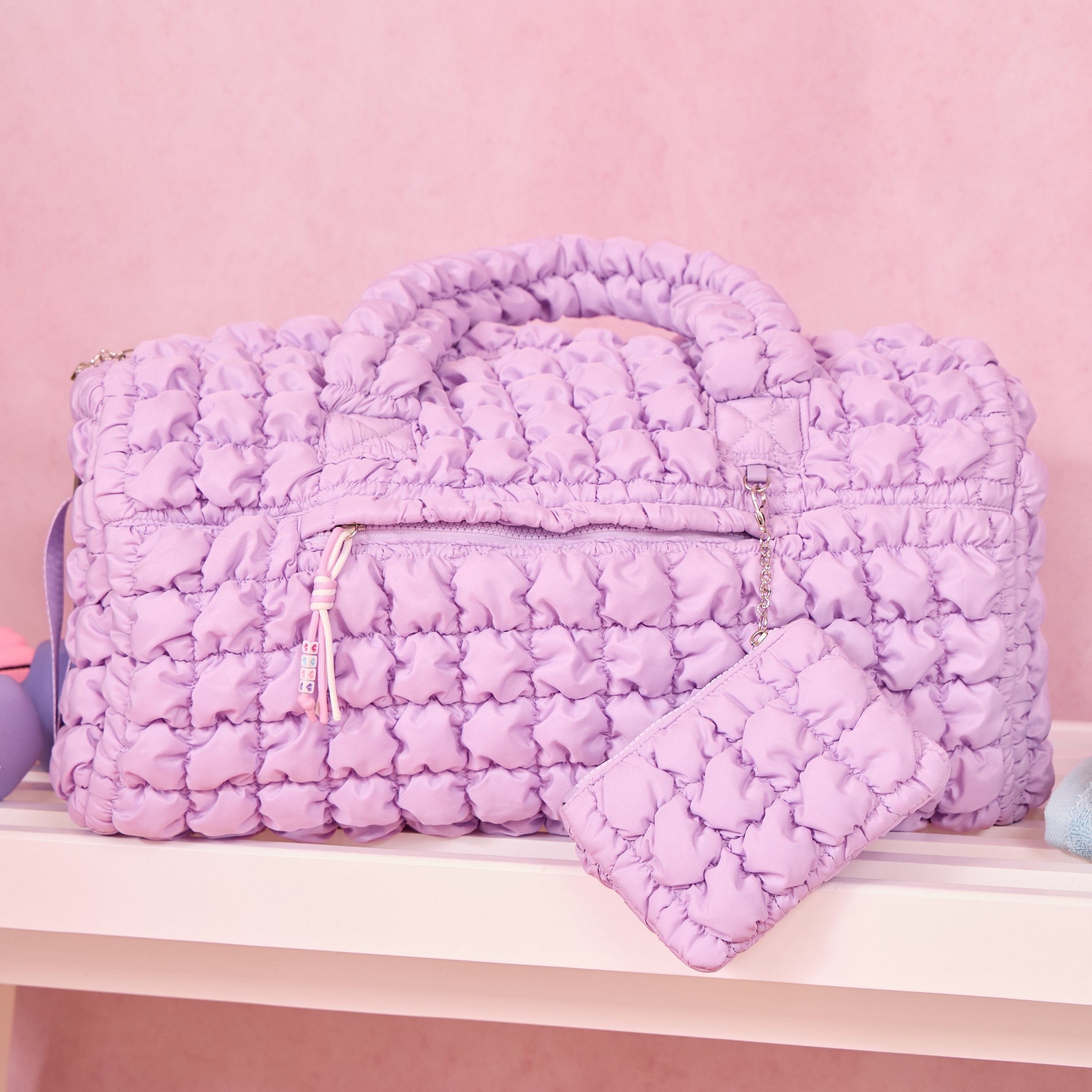 photoshoot photo of lavender quilted scrunchies duffle bag