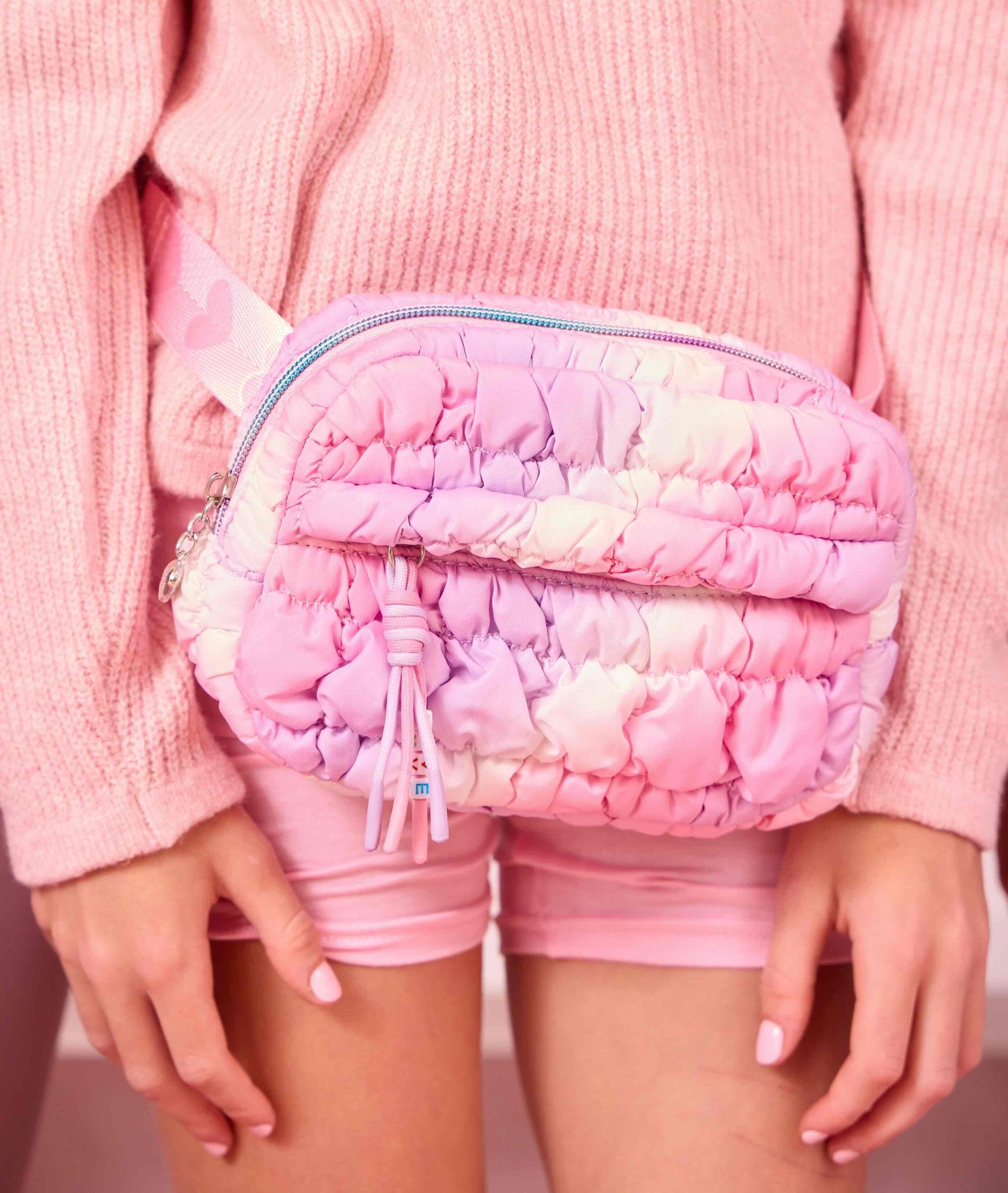 front view of a quilted nylon ombre fanny pack on model